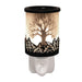 Black Tree of Life plug in wax melt burner glowing warmly with a cut-out silhouette design and on/off switch on the plug base.