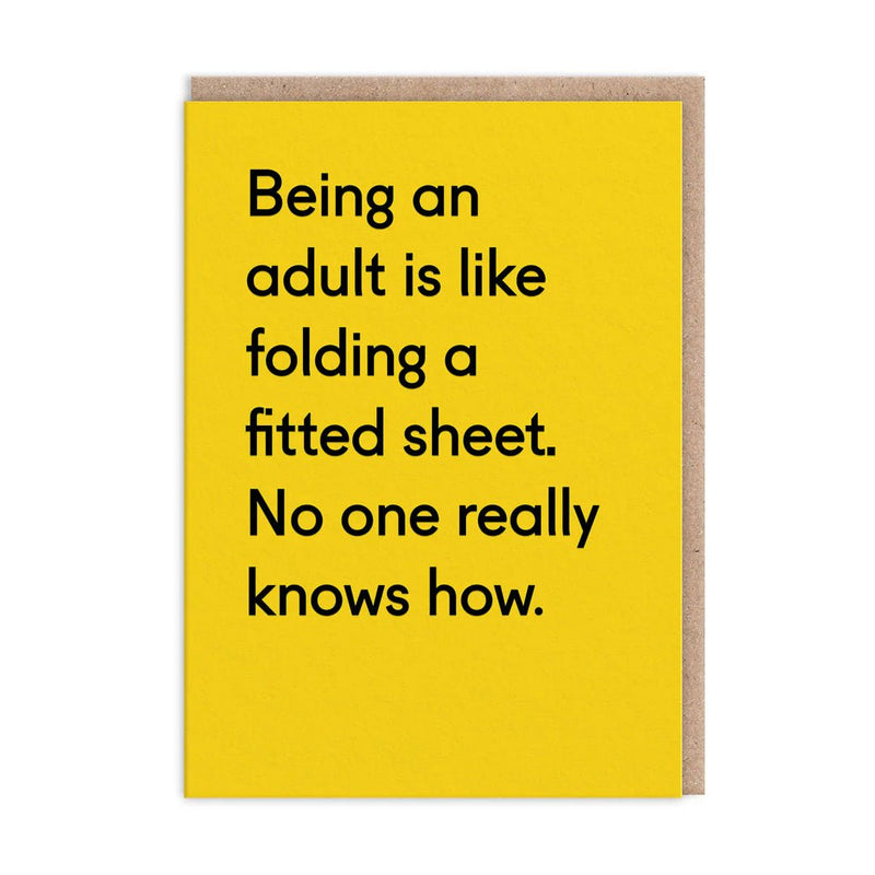 Yellow funny greeting card with black text about adulting being like folding a fitted sheet; A6, blank inside, kraft envelope by Twin Pines