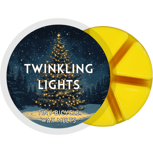 Twinkling Lights yellow segmented wax melt pot with illustrated Christmas tree covered in glowing fairy lights at night