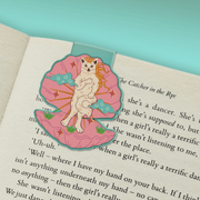 Venus Kitty magnetic bookmark marking a page in a book