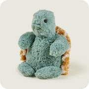 Side view of green Warmies turtle plush with brown patterned shell

