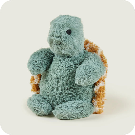 Side view of green Warmies turtle plush with brown patterned shell

