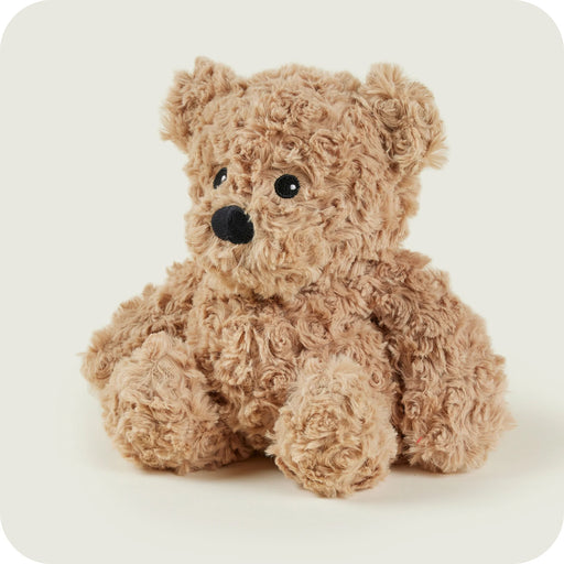 Sitting Warmies curly bear looking sideways with cute expression

