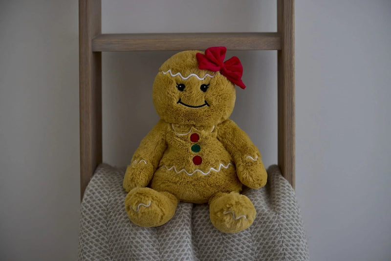 Warmies Gingerbread Girl plush on a blanket ladder in a cosy setting.