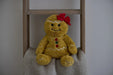 Warmies Gingerbread Girl plush on a blanket ladder in a cosy setting.