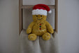 Warmies Gingerbread Man plush on a blanket ladder, cosy lifestyle setting.