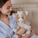 Child holding Warmies Goat plush toy on a sofa