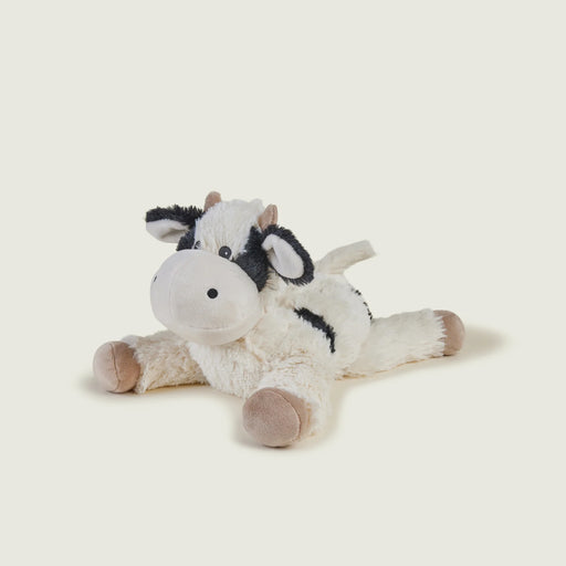 Angled view of Warmies Laying Cow heatable plush toy