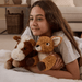 Child cuddling Warmies Laying Deer plush toy