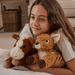 Child cuddling Warmies Laying Horse plush toy with fox plush