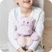 Child holding Warmies Marshmallow Hippo heatable plush toy