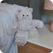Warmies Marshmallow Hippo plush toy sitting on a bedside table