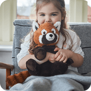 Child holding Warmies Red Panda heatable plush toy