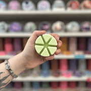 What-a-Melon green segmented wax melt held in hand