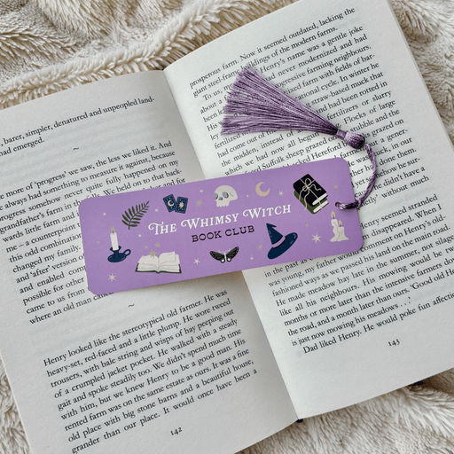 Whimsy Witch Book Club bookmark inside an open book