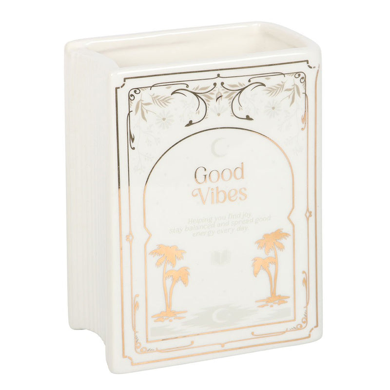 Upright white book shaped vase with Good Vibes cover design