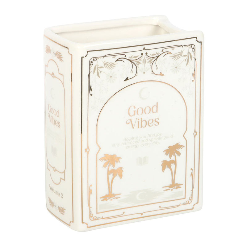 Front view of white Good Vibes ceramic book shaped vase