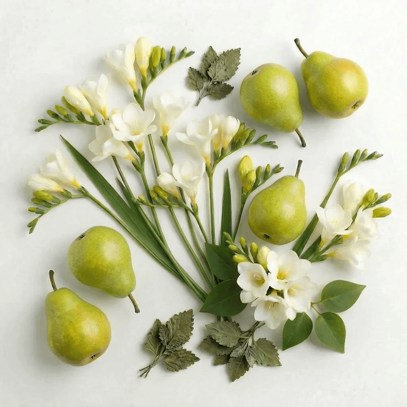 White freesia flowers and green pears representing the White Freesia & Pear diffuser fragrance