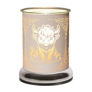 White Highland Cow wax melt burner lit with warm glow