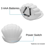Back of white pearl LED clam lamp showing 3 AAA battery compartment and power switch.