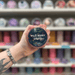 Wild Berry Grove wax melt pot held in hand with colourful wax melt display in the background