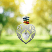 Angel Wing Heart Chakra suncatcher sparkling in sunshine against a leafy garden backdrop

