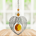 Topaz angel wing heart suncatcher with crystal octagon hanging in a bright window
