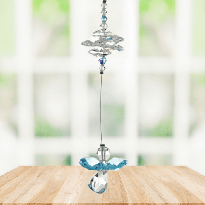 Aquamarine guardian angel crystal cascade suncatcher hanging in a bright window
