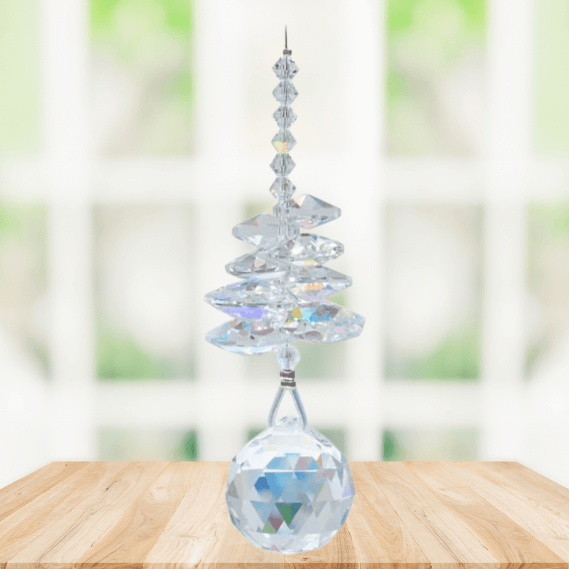 Wild Things Aurora Borealis birthstone crystal suncatcher hanging in a window with 20mm faceted ball pendant