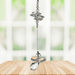 Aurora guardian angel crystal cascade suncatcher hanging in a bright window