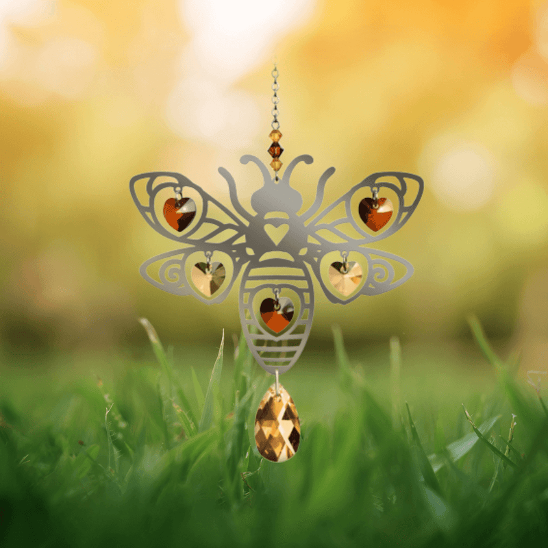 Bee crystal suncatcher glowing among autumn grass, ready to scatter warm golden rainbows

