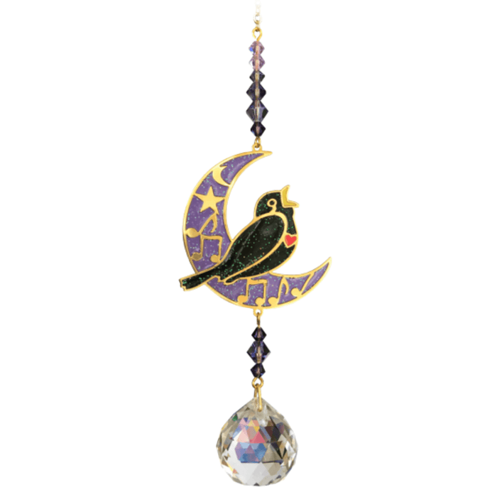 Blackbird Moonlight Crystal Suncatcher hanging in garden sunlight – blackbird on purple crescent moon with amethyst beads and 20 mm crystal ball rainbowing the air.
