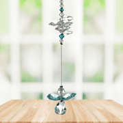 Blue zircon guardian angel crystal cascade suncatcher hanging in a bright window