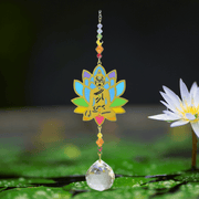 Buddha Rainbow Crystal Suncatcher above lily pond; gold Buddha lotus, chakra beads and sparkling crystal ball reflecting the water.

