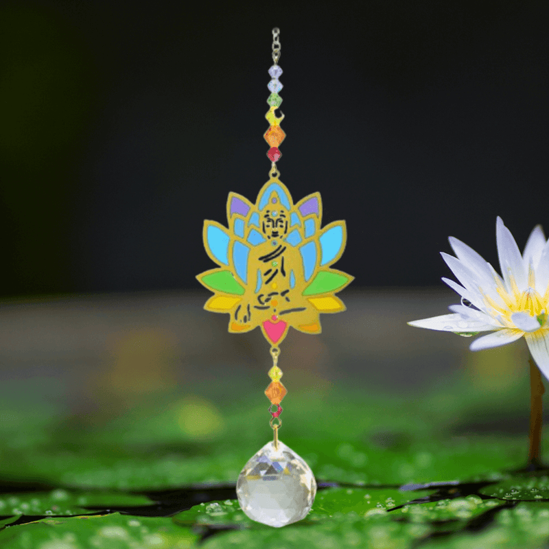 Buddha Rainbow Crystal Suncatcher above lily pond; gold Buddha lotus, chakra beads and sparkling crystal ball reflecting the water.


