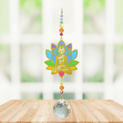 Buddha Rainbow Crystal Suncatcher hanging in bright window; rainbow lotus Buddha, multicoloured beads and faceted crystal prism ready to cast rainbows.
