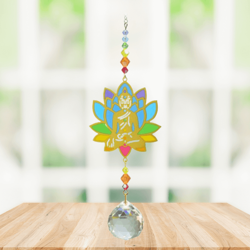 Buddha Rainbow Crystal Suncatcher hanging in bright window; rainbow lotus Buddha, multicoloured beads and faceted crystal prism ready to cast rainbows.
