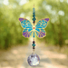 Butterfly Iris Crystal Suncatcher catching woodland light – turquoise-purple wings, crystal bead cascade and 20 mm prism casting colourful shards.

