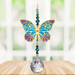Butterfly Iris Crystal Suncatcher hanging in a bright window; jewel-tone butterfly motif, faceted teal–amethyst beads and sparkling crystal ball.
