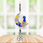 Cats on Roof – Moonlight Crystal Suncatcher hanging in bright window; crescent-moon skyline motif, faceted blue–smoke beads and sparkling crystal ball.

