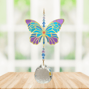 Wild Things Crystal Wonders iris butterfly crystal suncatcher hanging in a bright window, mirror-gold motif with teal and purple detail and 30mm crystal ball.