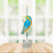 Wild Things Crystal Wonders kingfisher crystal suncatcher hanging in a bright window, mirror-gold bird motif in blue and gold with 30mm crystal ball pendant.