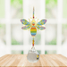 Wild Things Crystal Wonders rainbow bee crystal suncatcher hanging in a bright window, mirror-gold bee motif with rainbow detail and crystal ball pendant.