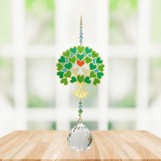 Wild Things Crystal Wonders Tree of Life green crystal suncatcher hanging in a bright window, mirror-gold motif with green detail and 30mm crystal ball pendant.