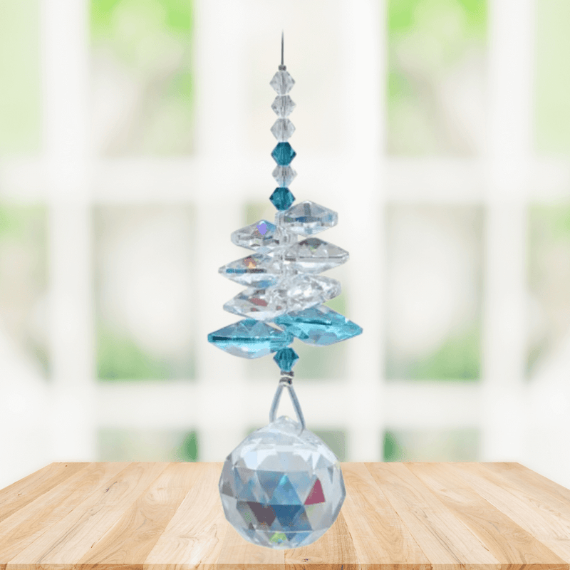 Wild Things Blue Zircon December birthstone crystal suncatcher hanging by window with 20mm faceted ball pendant