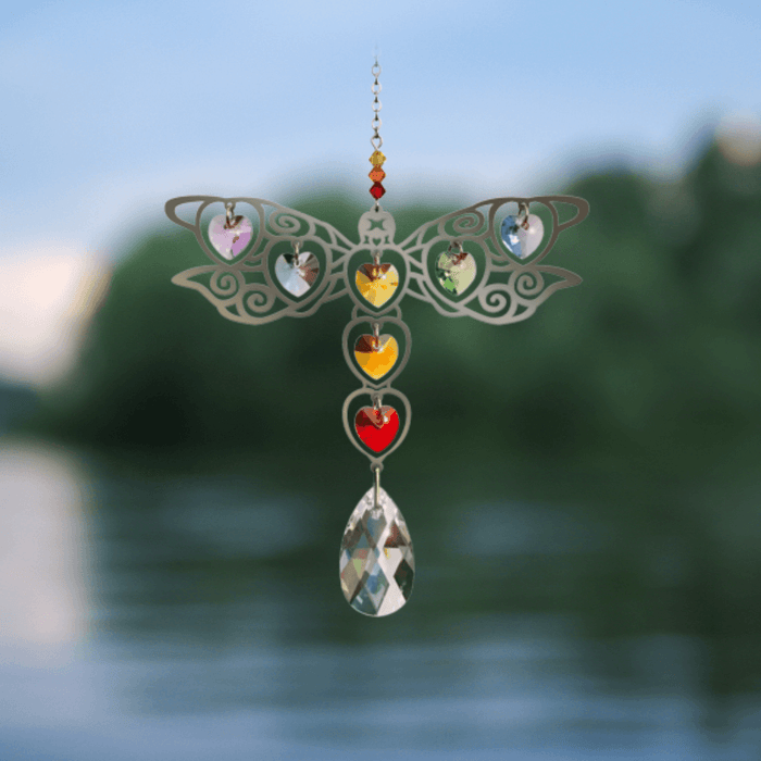 Dragonfly Rainbow crystal suncatcher sparkling over calm lake water at dusk

