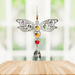 Handmade Dragonfly Rainbow crystal suncatcher displayed on a wooden table before a bright window

