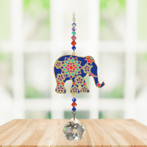 Elephant Indian Crystal Suncatcher hanging in a bright window; jewel-blue elephant motif, chakra-tone beads and sparkling crystal ball.
