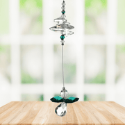 Emerald guardian angel crystal cascade suncatcher hanging in a bright window