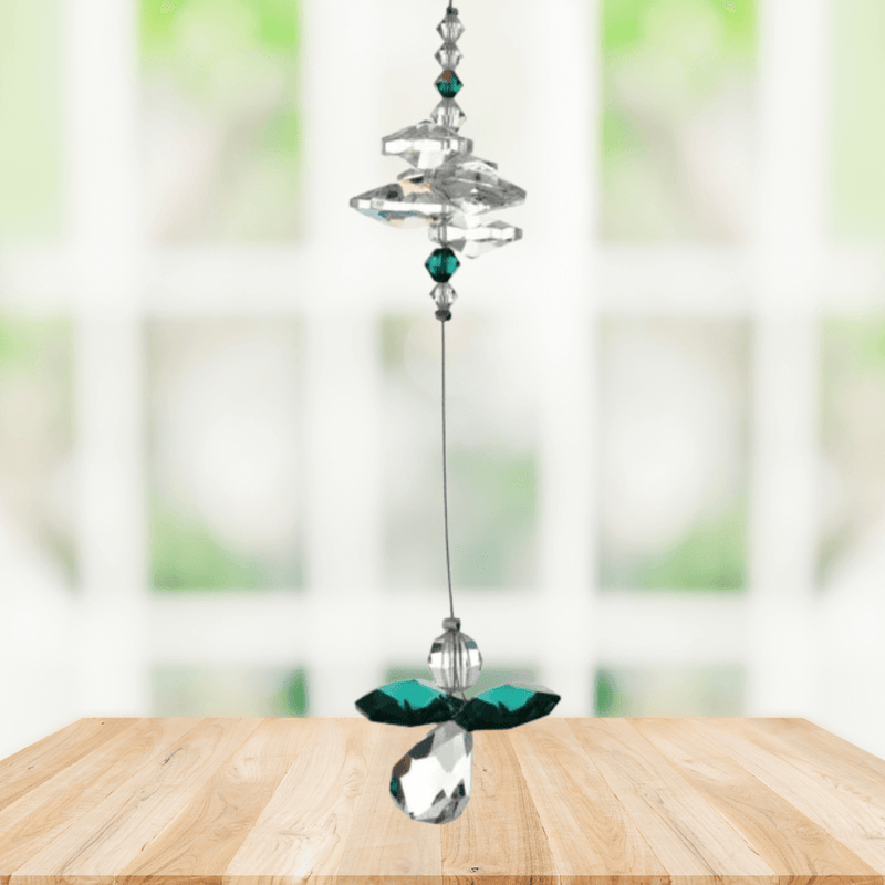 Emerald guardian angel crystal cascade suncatcher hanging in a bright window